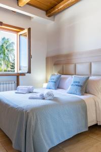 a bed with two towels on top of it at Corte San Lorenzo in Sant'Egidio del Monte Albino