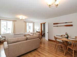 a living room with a couch and a table at Coastal Nest 30 Union Street in Seahouses