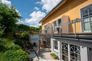 a balcony of a house with a patio at Hotel Sonnenklahr mit Pool in Göhren