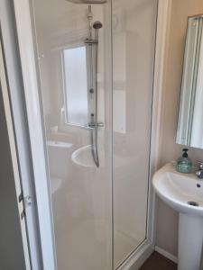 a bathroom with a shower and a sink at Luna-Rockley Park Poole in Poole