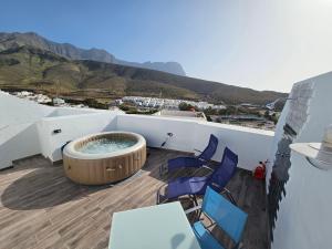 a balcony with a hot tub and chairs at Casa Buenavista Agaete in Agaete