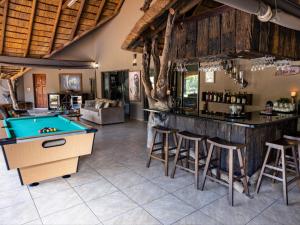 a bar with a pool table in a room at Sable Ranch Bush Lodge in Brits