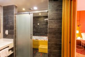 a bathroom with a shower and a bath tub at Kuhla Hotel in Trabzon +46 photos