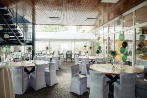 a banquet hall with tables and chairs and balloons at Hotel Fontána in Brno