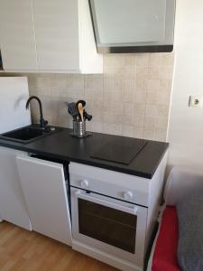 a kitchen with a black counter top and a sink at Apartment Lorena in Split