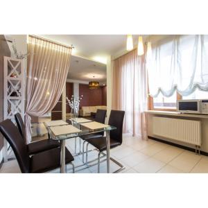 a dining room and living room with a table and chairs at Naykova district in Kharkiv