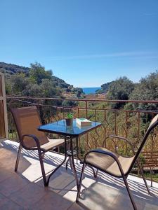 a table and chairs on a balcony with a view at DANDOLOS STUDIOS in Parga