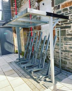 a group of stools sitting under a table at New Town Hall Bunkhouse in Whithorn