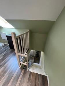 a staircase in a room with wooden floors at Duplex paisible à la campagne in Relans