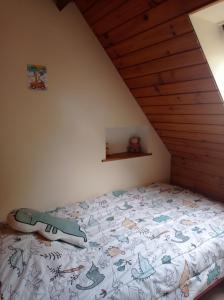 a bedroom with a bed in a attic at Le Relais des Trois Cépages in Sassetot-le-Mauconduit