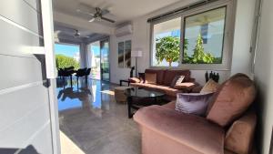 a living room with two couches and a table at Protaras LUX Villa, Swimming pool, BBQ grill, Near beach in Protaras