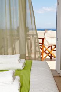 Ένα ή περισσότερα κρεβάτια σε δωμάτιο στο Amarandos Sea View Apartments