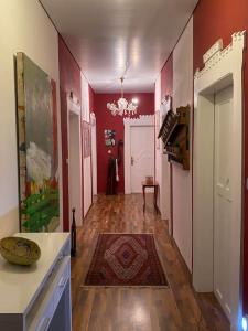 a room with a hallway with red walls at Ferienwohnung in historischer Villa! in Furth im Wald