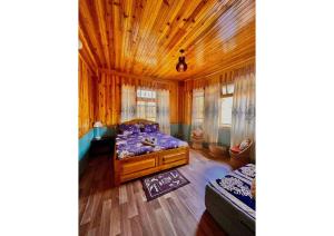 a bedroom with a bed and a wooden ceiling at Twillight hometsay in Darjeeling