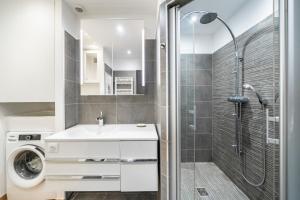 W łazience znajduje się prysznic, umywalka i pralka. w obiekcie Baie Roquebrune, Balcon Vue Mer, Parking Gratuit - AO w mieście Roquebrune-Cap-Martin +21 zdjęć