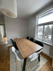 a dining room with a wooden table and chairs at Apartment in historical house in Oslo