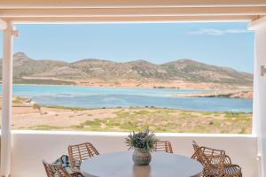 a table and chairs with a view of the ocean at Antiparos Thea in Antiparos