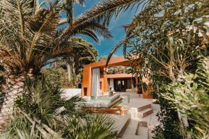 a house with palm trees in front of it at Zori Timeless Hotel in Hvar