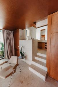 a living room with a staircase in a house at Zori Timeless Hotel in Hvar