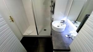 a bathroom with a sink and a shower at Best Western Hôtel Royan Océan in Royan