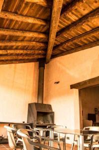 a room with chairs and a table and a stove at La Casa de la Quesería in Albarracín