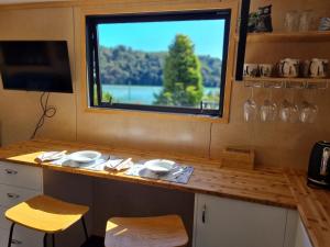 a small kitchen with a counter with a window at Kaiteriteri Tiny Home in Kaiteriteri