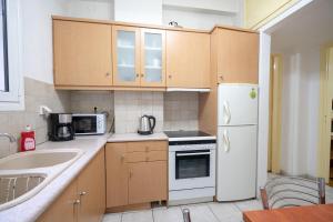 a kitchen with a white refrigerator and a sink at Kipseli 1 bedroom 5 persons apartment by MPS in Athens