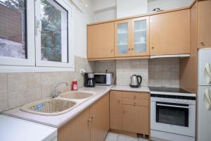 a kitchen with a sink and a microwave at Kipseli 1 bedroom 5 persons apartment by MPS in Athens