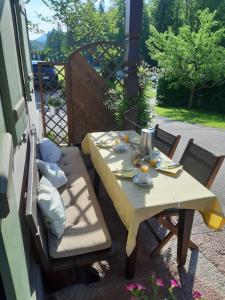 a yellow table and chairs on a patio at Landhaus Degen in Bischofswiesen +37 photos