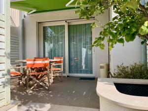 a patio with orange chairs and a table at B&B Villa Pini in Civitanova Marche