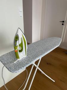 a ironing board sitting on top of a chair at Księżycowy Apartament Ursus in Warsaw