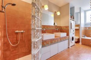 łazienka z prysznicem, 2 umywalkami i pralką w obiekcie Appartement de charme en centre-ville pour 6 pers. w mieście Nantes