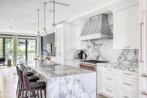 a kitchen with white cabinets and a marble counter top at 2BR Gowanus Townhouse w WD nr Prospect Park NYC-883 in Brooklyn