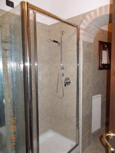 a bathroom with a shower with a glass door at OPERA THEATER APARTMENT - ROMA CENTER in Rome