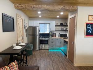 a kitchen with a dining table and a kitchen with a counter at Red And Blue 4 U With High Speed Wifi in Red River