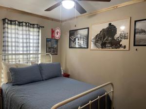 a bedroom with a bed with a train on the wall at Red And Blue 4 U With High Speed Wifi in Red River +18 photos