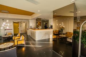 a man standing at a counter in a hotel lobby at Taormina Panoramic Hotel in Taormina +37 photos