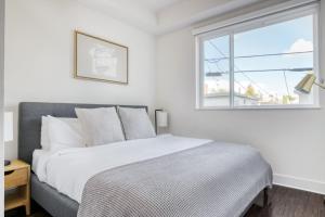 a white bedroom with a bed and a window at Culver City 2br w gym lounge roof nr 405 LAX-1001 in Los Angeles