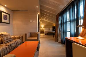 a living room with a couch and a table at Hotel La Trufa Negra in Mora de Rubielos