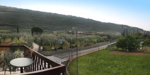 a balcony with a view of a road and a mountain at Albergo Garni Orchidea in Riva del Garda