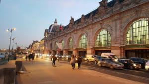 a group of people walking down a street in front of a building at Paris 15 Expo Versailles Park Free in Issy-les-Moulineaux