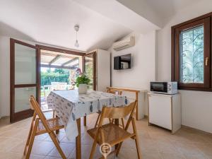 cocina y comedor con mesa y sillas en Sunny Garden House en Simius