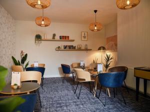 a dining room with tables and chairs and lights at Linton Lodge a BW Signature Collection Hotel in Oxford