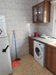 a kitchen with a washing machine in a kitchen at شقه مفروشة الجبيهه in Amman