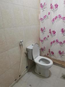 a bathroom with a toilet and a shower curtain at شقه مفروشة الجبيهه in Amman +65 photos