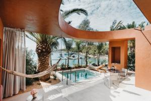 a house with a hammock and a swimming pool at Zori Timeless Hotel in Hvar