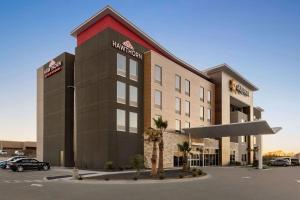 a rendering of a hotel with a parking lot at La Quinta Inn & Suites by Wyndham Del Rio in Del Rio