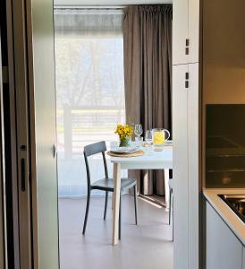 a kitchen with a table and chairs and a window at Agricampeggio Le Bucoliche in Colà di Lazise