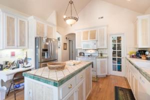 a kitchen with white cabinets and a basket on a counter at Annandale - V067 in Lake Arrowhead