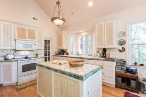 a kitchen with white cabinets and a large island at Annandale - V067 in Lake Arrowhead